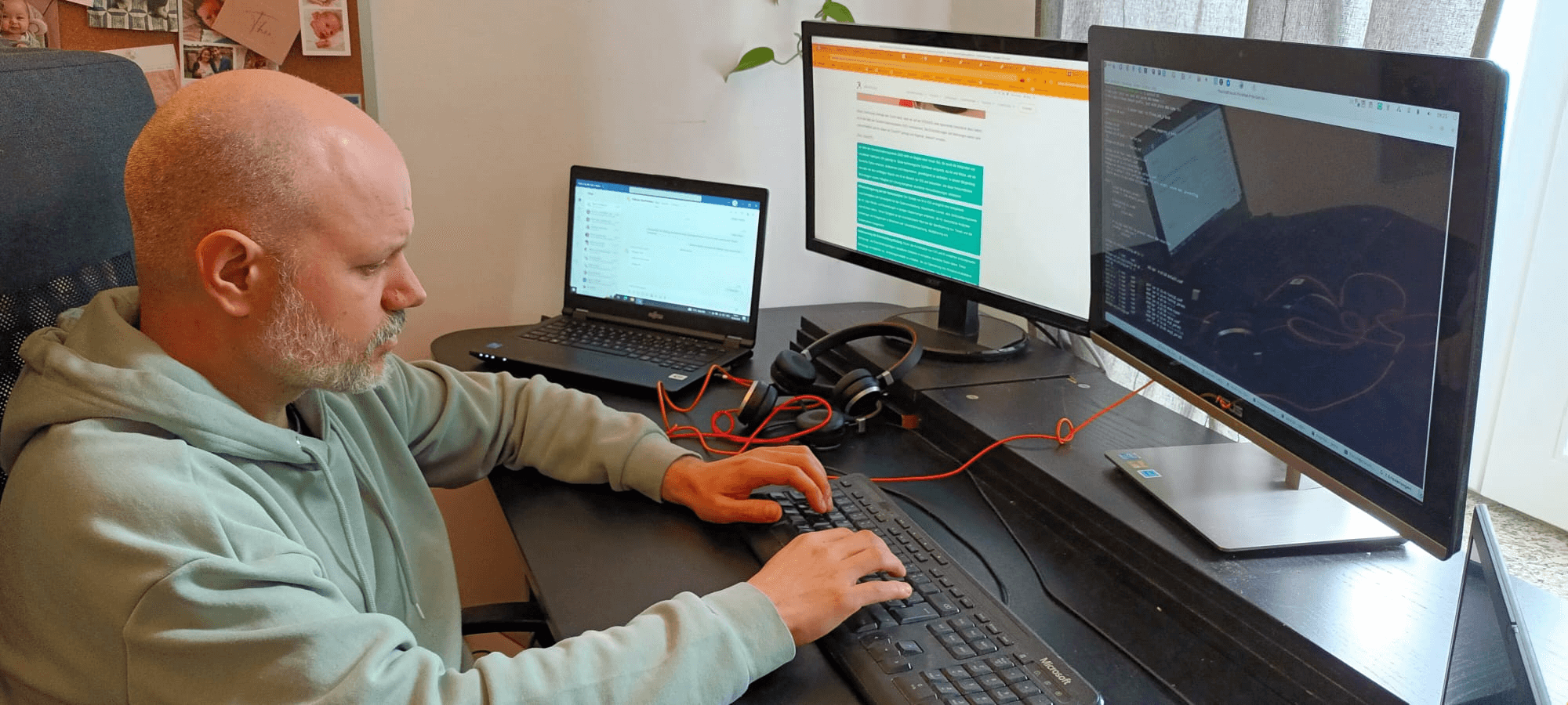 Mann vor einem PC mit 3 Bildschirmen